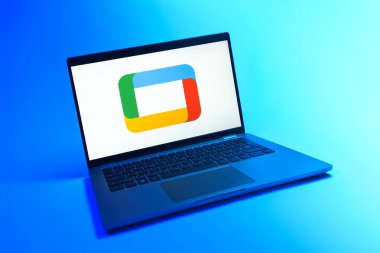 Prague, Czechia - 08 12 2025: A dynamic view of a laptop on a uniform background displaying the Google TV logo. Google TV is a platform for streaming movies, shows, and apps.