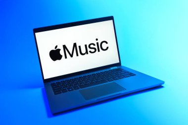 Prague, Czechia - 08 12 2025: A dynamic view of a laptop on a uniform background displaying the Apple Music logo. Apple Music is a platform for streaming and discovering music.
