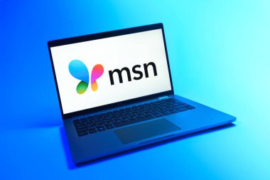 Prague, Czechia - 08 12 2025: A dynamic view of a laptop on a uniform background displaying the MSN logo. MSN is a platform for news, email, and online services.
