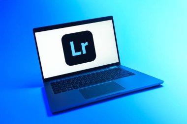 Prague, Czechia - 08 12 2025: A dynamic view of a laptop on a uniform background displaying the Lightroom logo. Lightroom is a software for photo editing and management.