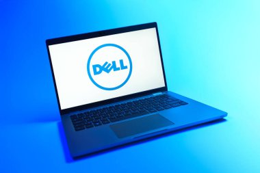 Prague, Czechia - 08 12 2025: A dynamic view of a laptop on a uniform background displaying the Dell logo. Dell is a technology company producing computers and IT solutions.