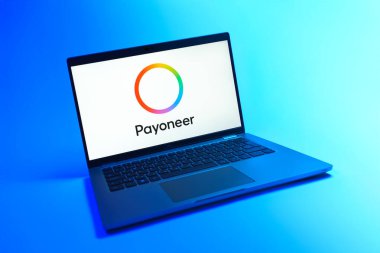 Prague, Czechia - 08 12 2025: A dynamic view of a laptop on a uniform background displaying the Payoneer logo. Payoneer is a platform for global online payments and money transfers.