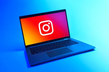 Prague, Czechia - 08 12 2025: A dynamic view of a laptop on a uniform background displaying the Instagram logo. Instagram is a social media platform for sharing photos and videos.