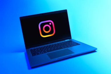 Prague, Czechia - 08 12 2025: A dynamic view of a laptop on a uniform background displaying the Instagram logo. Instagram is a social media platform for sharing photos and videos.