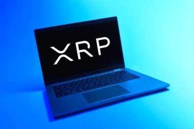 Prague, Czechia - 08 12 2025: A dynamic view of a laptop on a uniform background displaying the Ripple logo. Ripple is a digital cryptocurrency and payment protocol.