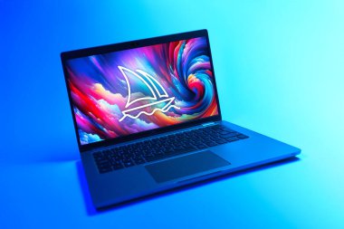 Prague, Czechia - 08 12 2025: A dynamic view of a laptop on a uniform background displaying the Midjourney logo. Midjourney is a platform for AI-generated images and art.