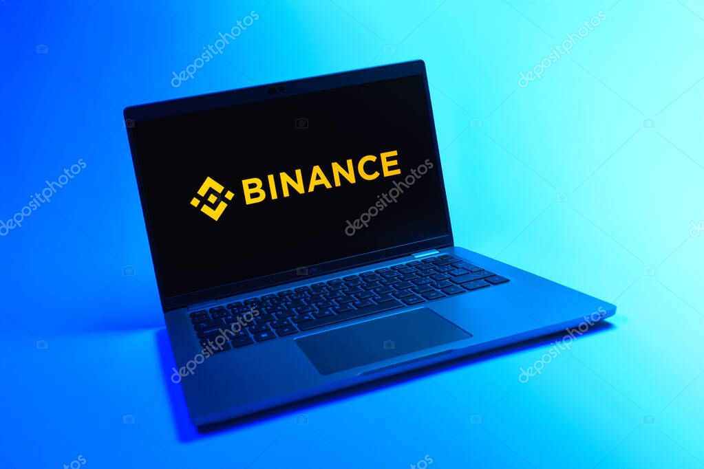 Prague, Czechia - 08 12 2025: A dynamic view of a laptop on a uniform background displaying the Binance logo. Binance is a cryptocurrency exchange for trading digital assets.