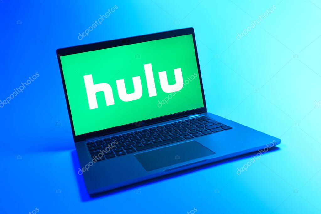 Prague, Czechia - 08 12 2025: A dynamic view of a laptop on a uniform background displaying the Hulu logo. Hulu is a streaming platform for TV shows, movies, and live TV.