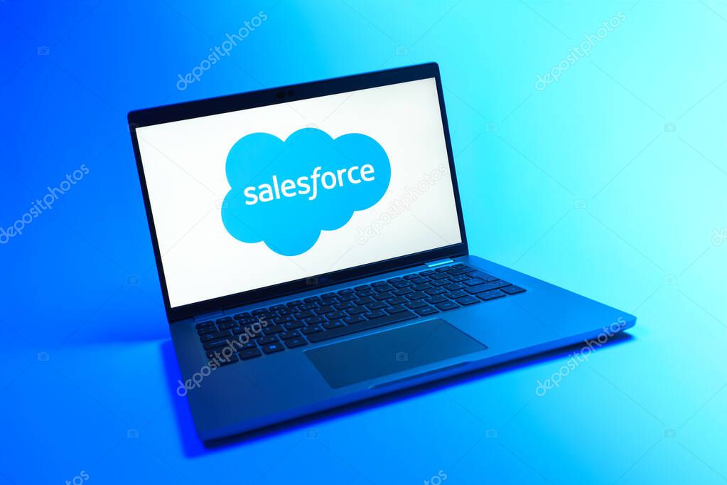 Prague, Czechia - 08 12 2025: A dynamic view of a laptop on a uniform background displaying the Salesforce logo. Salesforce is a platform for customer relationship management and cloud services.