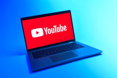Prague, Czechia - 08 12 2025: A dynamic view of a laptop on a uniform background displaying the Youtube logo. Youtube is a platform to watch and share videos worldwide.