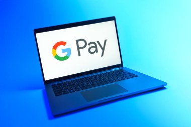Prague, Czechia - 08 12 2025: A dynamic view of a laptop on a uniform background displaying the Google Pay logo. Google Pay is a platform for easy and secure digital payments.