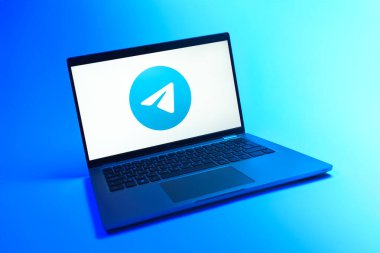 Prague, Czechia - 08 12 2025: A dynamic view of a laptop on a uniform background displaying the Telegram logo. Telegram is an app for fast and secure messaging.