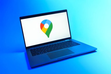 Prague, Czechia - 08 12 2025: A dynamic view of a laptop on a uniform background displaying the Google Maps logo. Google Maps is a platform for maps, navigation, and location services.