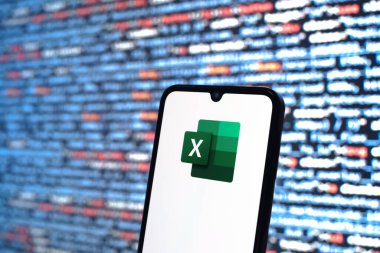 Prague, Czechia - 08 12 2025: Phone in front of a screen showing the Excel logo. Excel is a software for spreadsheets, data analysis, and calculations.