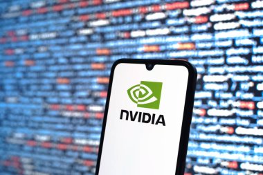 Prague, Czechia - 08 12 2025: Phone in front of a screen showing the NVIDIA logo. NVIDIA is a technology company specializing in GPUs and AI hardware.