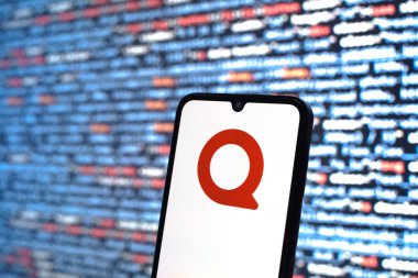 Prague, Czechia - 08 12 2025: Phone in front of a screen showing the Quora logo. Quora is a platform for asking questions and sharing knowledge.