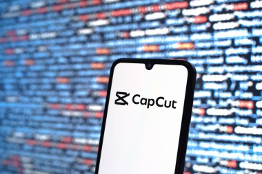 Prague, Czechia - 08 12 2025: Phone in front of a screen showing the CapCut logo. CapCut is a platform for editing and creating videos.
