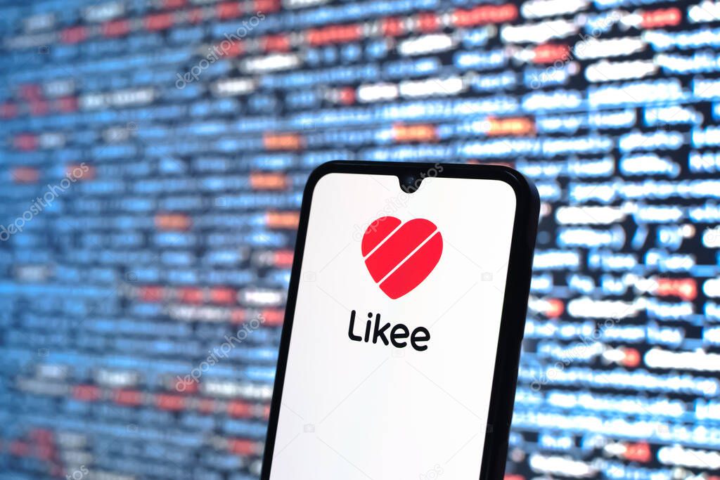 Prague, Czechia - 08 12 2025: Phone in front of a screen showing the Likee logo. Likee is a platform for creating and sharing short videos.