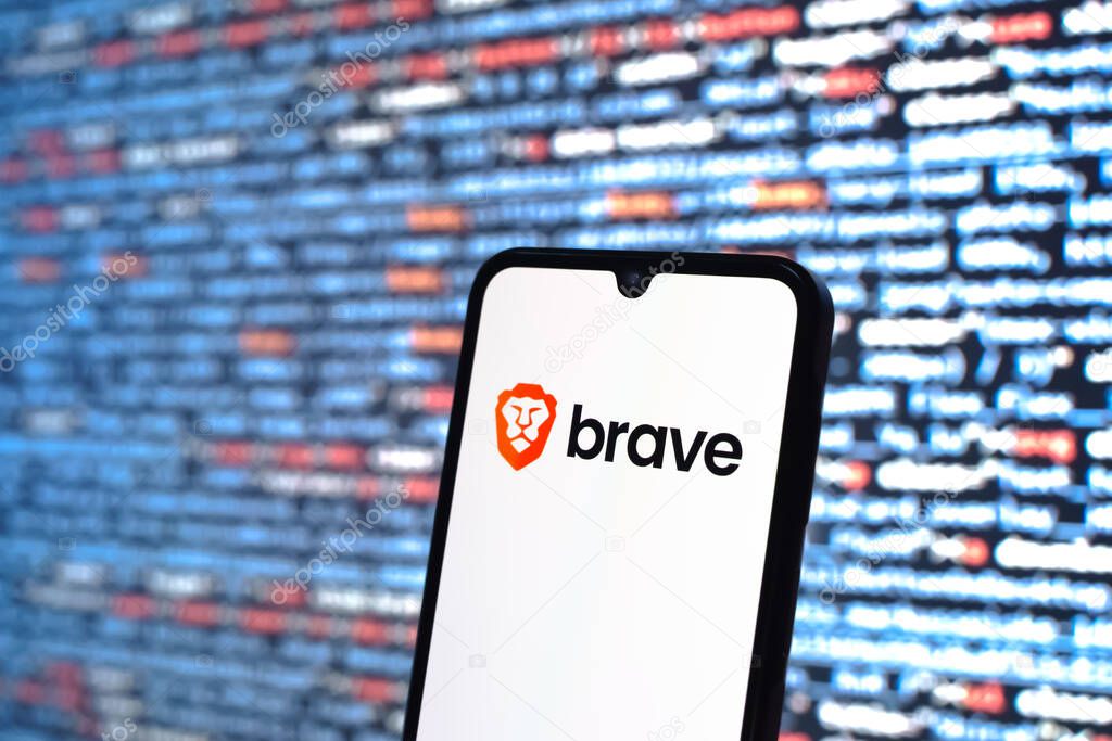 Prague, Czechia - 08 12 2025: Phone in front of a screen showing the Brave logo. Brave is a web browser focused on privacy and speed.