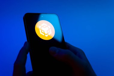 Prag, Çek Cumhuriyeti - 08 12 2025: Eller mavi arkaplanda Discord logosunu gösteren bir cep telefonu tutuyor. Discord ses, video ve metin iletişimi için bir platformdur..