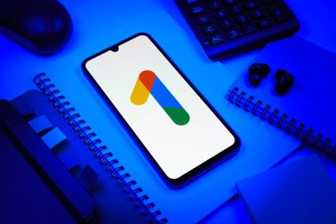 Prag, Çek Cumhuriyeti - 08 18 2025: Merkezinde Google One logosu bulunan bir cep telefonu ile ofis malzemeleri düzenlemesi. Google 1 bulut depolama ve abonelik hizmetleri için bir platformdur.