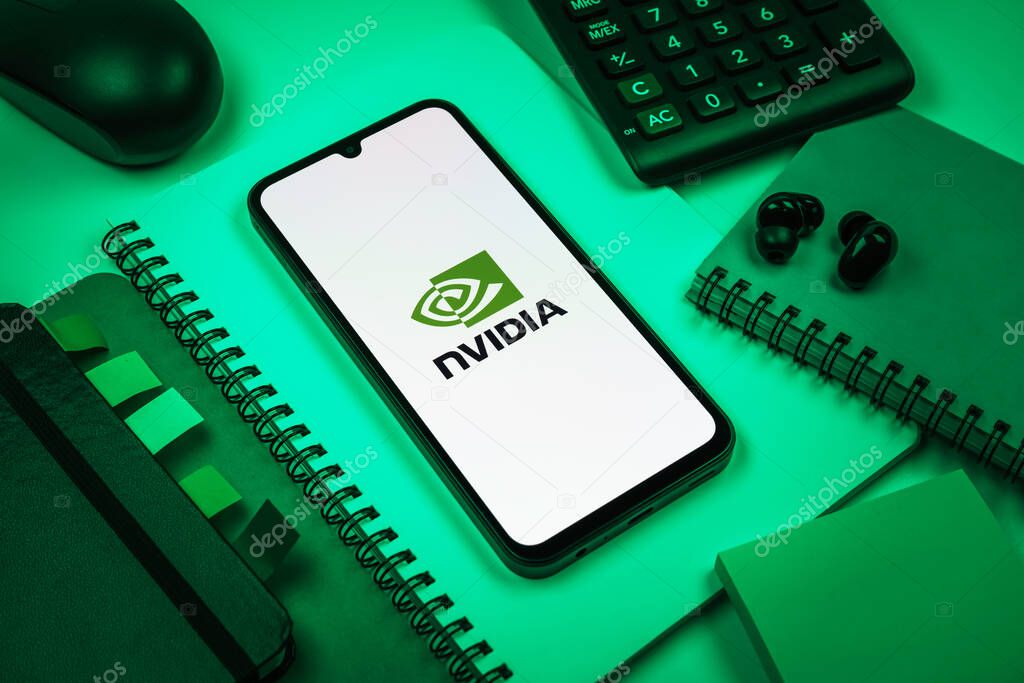 Prague, Czechia - 08 18 2025: An arrangement of office supplies with a mobile phone in the center displaying NVIDIA logo. NVIDIA is a technology company specializing in GPUs and AI hardware.
