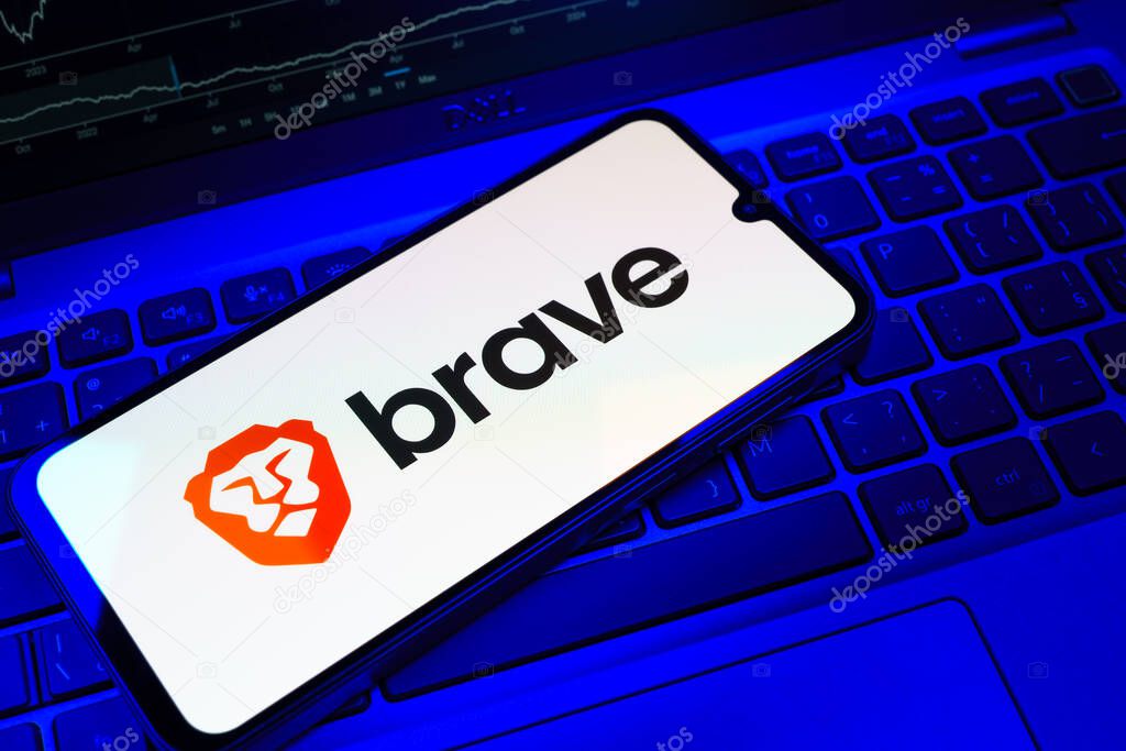 Prague, Czechia - 08 18 2025: A mobile phone on a keyboard displays Brave logo. Brave is a web browser focused on privacy and speed.