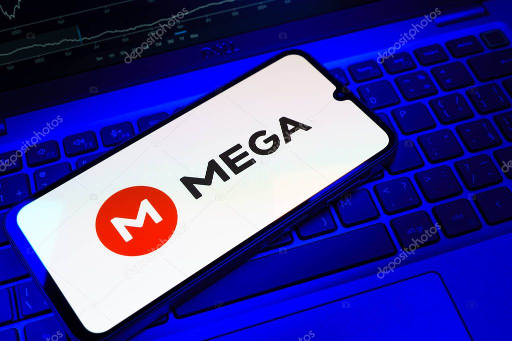 Prague, Czechia - 08 18 2025: A mobile phone on a keyboard displays Mega logo. Mega is a platform for cloud storage with encrypted file sharing.
