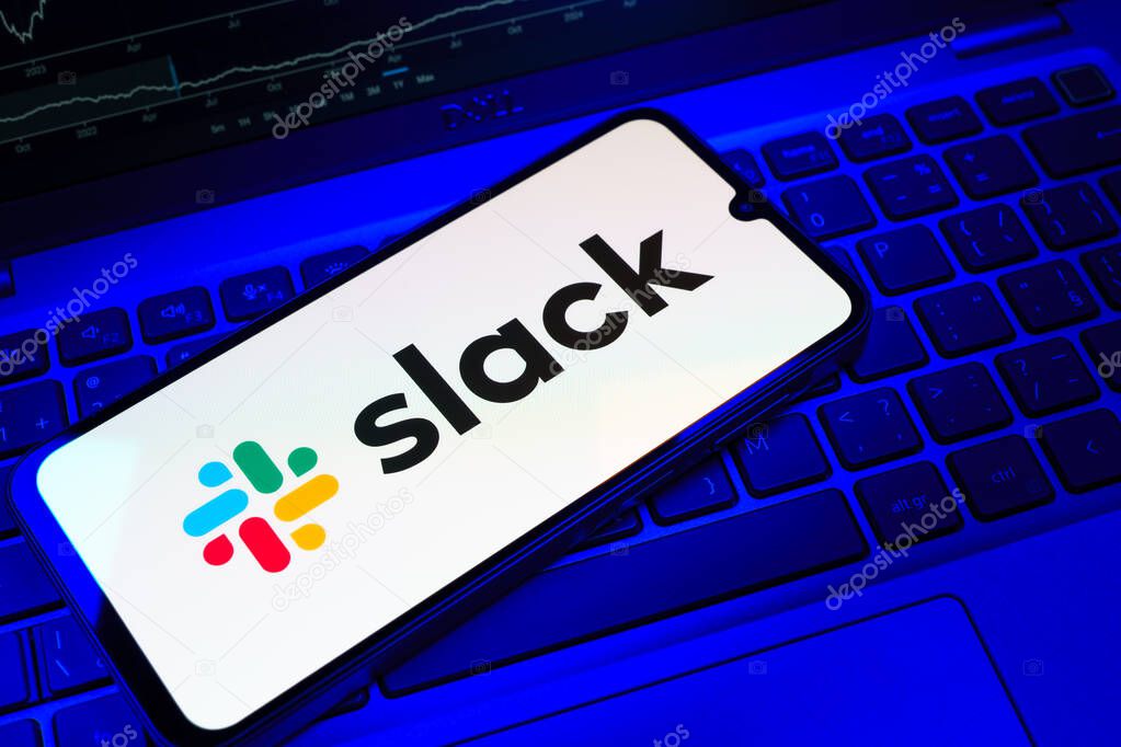Prague, Czechia - 08 18 2025: A mobile phone on a keyboard displays Slack logo. Slack is a platform for team messaging and workplace communication.