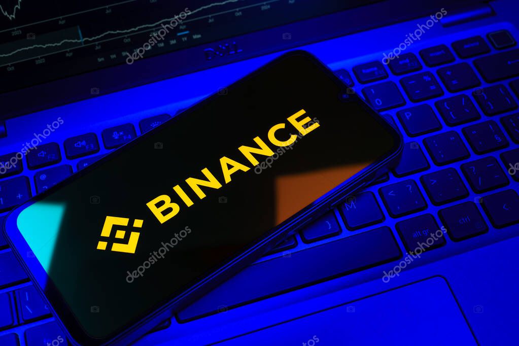 Prague, Czechia - 08 18 2025: A mobile phone on a keyboard displays Binance logo. Binance is a cryptocurrency exchange for trading digital assets.