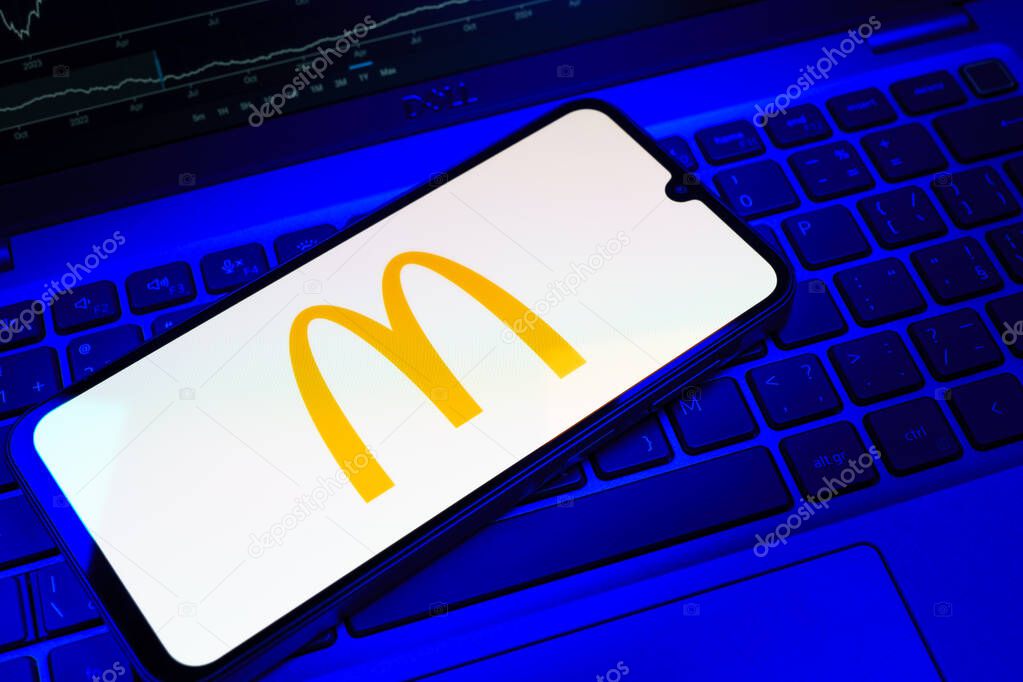 Prague, Czechia - 08 18 2025: A mobile phone on a keyboard displays McDonalds logo. McDonalds is a fast-food chain serving burgers, fries, and more.