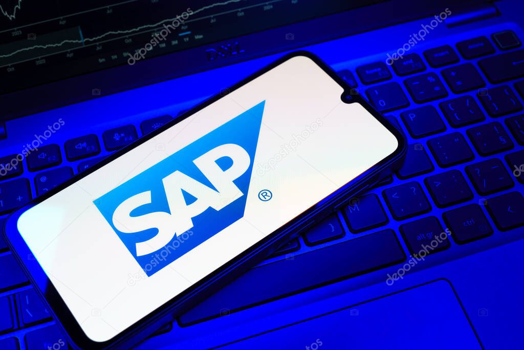 Prague, Czechia - 08 18 2025: A mobile phone on a keyboard displays SAP logo. SAP is a software company providing enterprise applications and solutions.