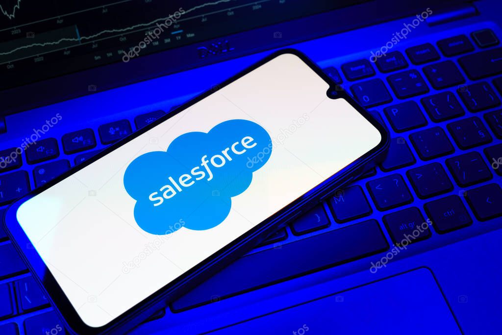 Prague, Czechia - 08 18 2025: A mobile phone on a keyboard displays Salesforce logo. Salesforce is a platform for customer relationship management and cloud services.