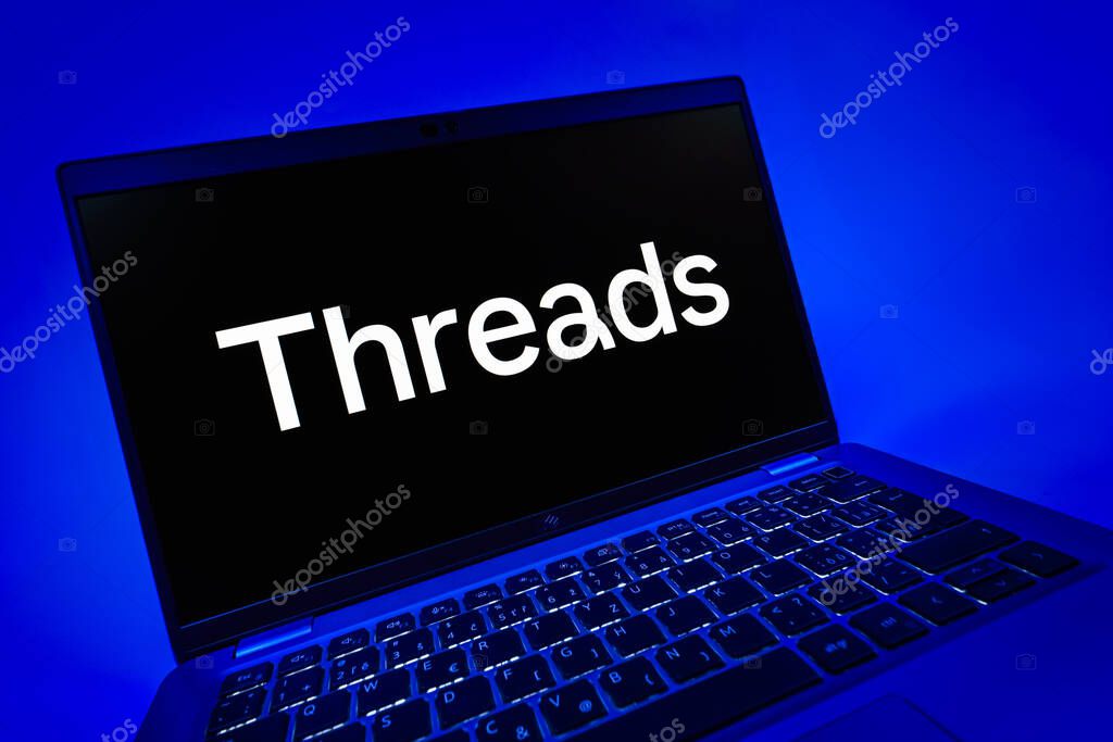 Prague, Czechia - 08 12 2025: A dynamic close-up of a laptop displaying the Threads logo. Threads is a social media platform for sharing short posts and updates.