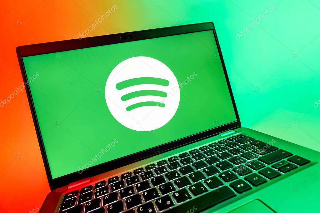 Prague, Czechia - 08 12 2025: A dynamic close-up of a laptop displaying the Spotify logo. Spotify is a platform for streaming and discovering music.