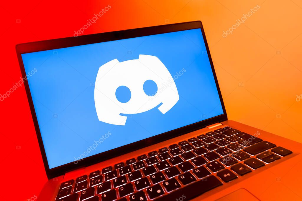 Prague, Czechia - 08 12 2025: A dynamic close-up of a laptop displaying the Discord logo. Discord is a platform for voice, video, and text communication.