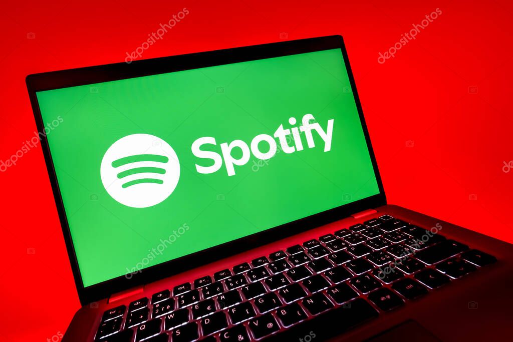 Prague, Czechia - 08 12 2025: A dynamic close-up of a laptop displaying the Spotify logo. Spotify is a platform for streaming and discovering music.