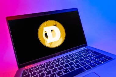 Prag, Çek Cumhuriyeti - 08 12 2025: Dogecoin logosunu gösteren bir dizüstü bilgisayarın dinamik yakın çekimi. Dogecoin, paylaşımcı işlemler için kullanılan bir şifreli para birimidir.