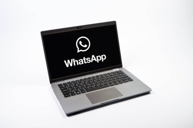 Prag, Çek Cumhuriyeti - 08 12 2025: Tek bir arkaplanda WhatsApp logosunu gösteren bir dizüstü bilgisayarın yukarıdan görünüşü. WhatsApp mesaj, çağrı ve medya göndermek için bir uygulamadır.