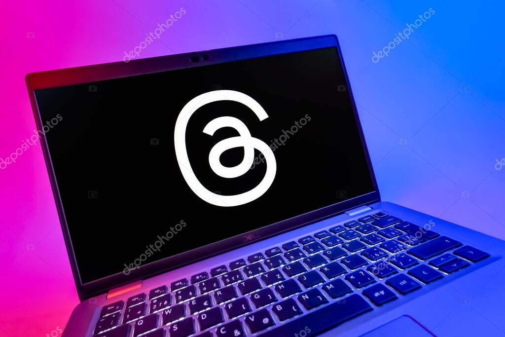 Prague, Czechia - 08 12 2025: A dynamic close-up of a laptop displaying the Threads logo. Threads is a social media platform for sharing short posts and updates.