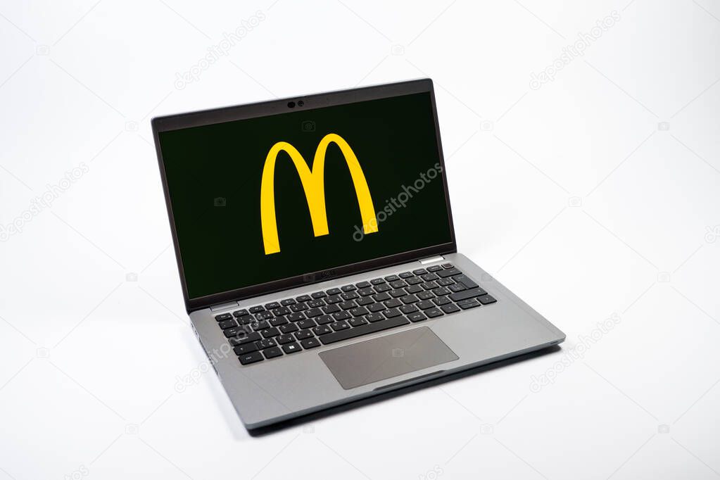 Prague, Czechia - 08 12 2025: A top-down view of a laptop on a uniform background displaying the McDonalds logo. McDonalds is a fast-food chain serving burgers, fries, and more.
