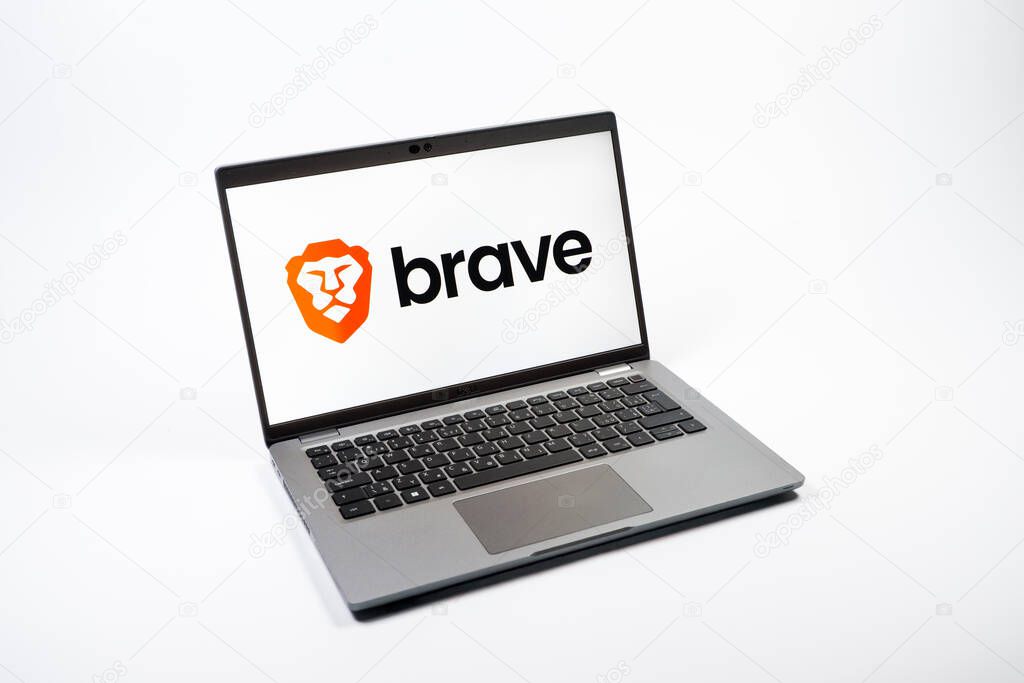 Prague, Czechia - 08 12 2025: A top-down view of a laptop on a uniform background displaying the Brave logo. Brave is a web browser focused on privacy and speed.