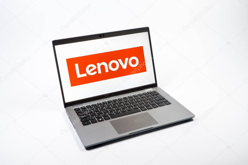 Prague, Czechia - 08 12 2025: A top-down view of a laptop on a uniform background displaying the Lenovo logo. Lenovo is a technology company producing computers and electronics.