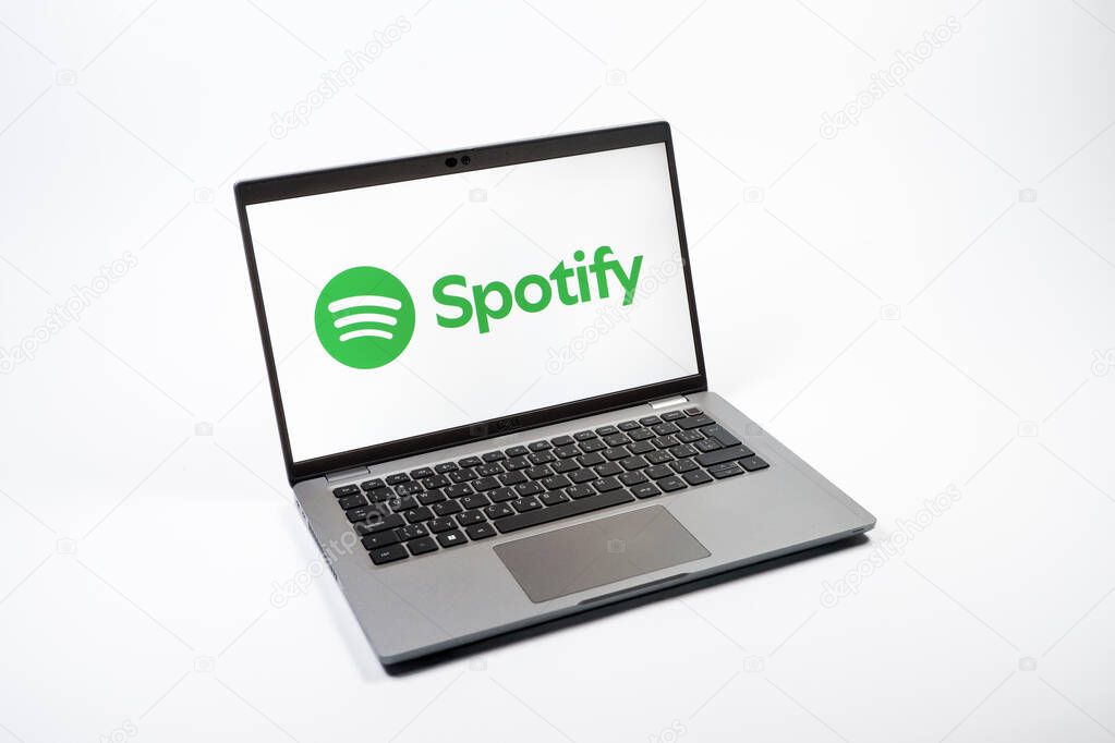 Prague, Czechia - 08 12 2025: A top-down view of a laptop on a uniform background displaying the Spotify logo. Spotify is a platform for streaming and discovering music.