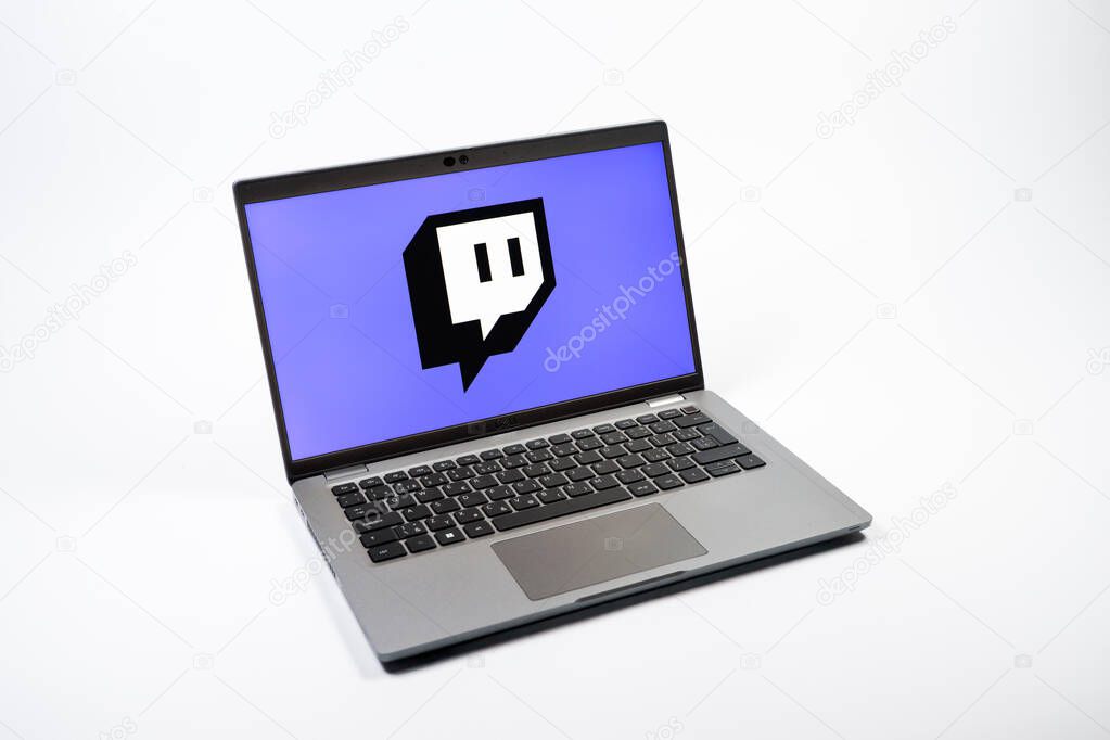 Prague, Czechia - 08 12 2025: A top-down view of a laptop on a uniform background displaying the Twitch logo. Twitch is a platform for live streaming games and content.