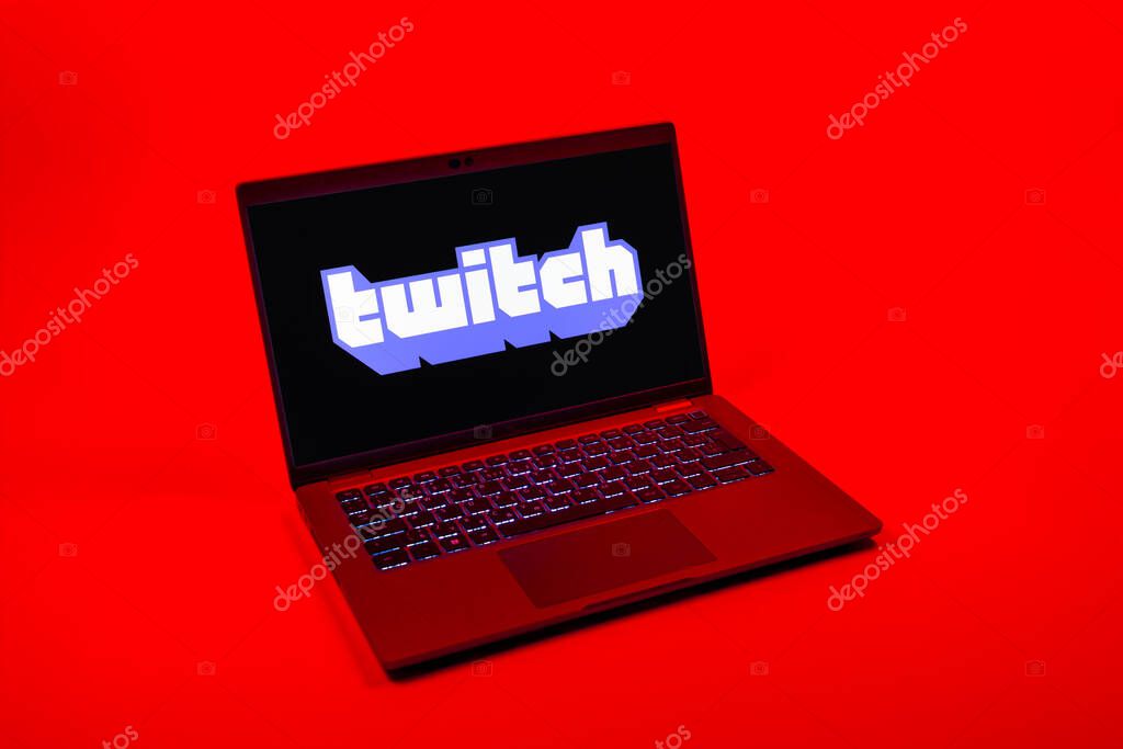 Prague, Czechia - 08 12 2025: A top-down view of a laptop on a uniform background displaying the Twitch logo. Twitch is a platform for live streaming games and content.