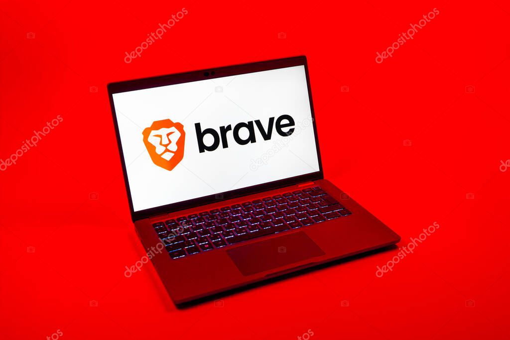 Prague, Czechia - 08 12 2025: A top-down view of a laptop on a uniform background displaying the Brave logo. Brave is a web browser focused on privacy and speed.