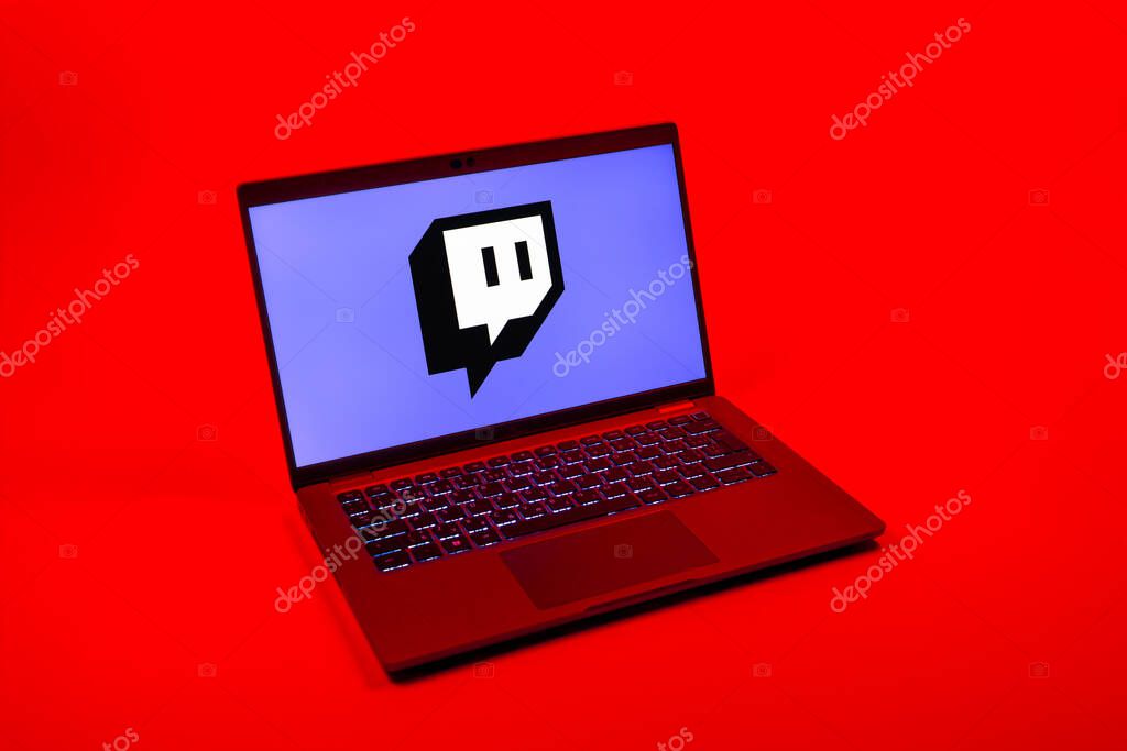 Prague, Czechia - 08 12 2025: A top-down view of a laptop on a uniform background displaying the Twitch logo. Twitch is a platform for live streaming games and content.