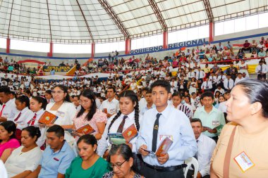 Tumbes, Tumbes, Peru 21-10-2023, Ayin Ayini: Bir stadyumda toplanan bir kalabalık, bazıları kitap tutuyor. Atmosfer canlı ve enerjik, her yaştan ve cinsiyetten insan mevcut. Olay bir kitap okuma olabilir.