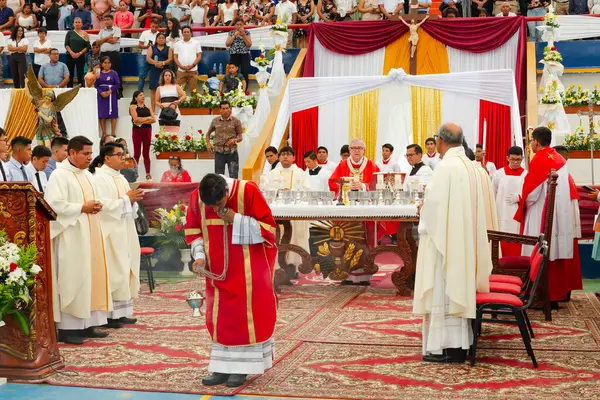 Tumbes, Tumbes, Peru 21-10-2023, Onaylama Töreni: Bir grup rahip kırmızı cüppeli bir adamın önlerinde durduğu bir masanın etrafında toplandı.